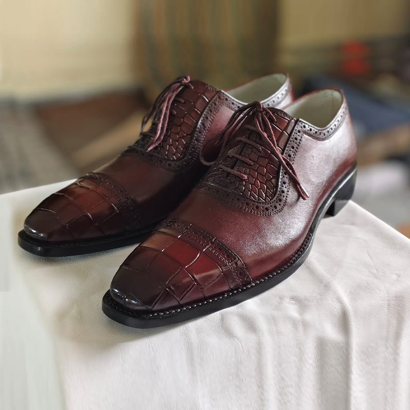 Handmade men’s burgundy crocodile embossed leather Oxford dress shoes with cap toe and lace-up design left view